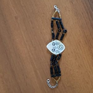 Engraved mother of pearl, shell, and bead Bali bracelet.